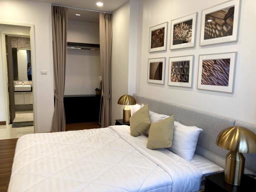 Elegant bedroom with en-suite bathroom and curated artwork