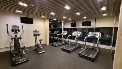 Well-equipped modern gym with treadmills and exercise bikes