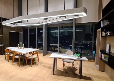 Modern kitchen with dining area and city view at night