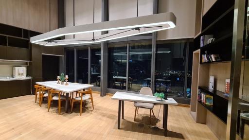 Modern kitchen with dining area and city view at night