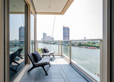 Modern balcony overlooking the river with outdoor seating