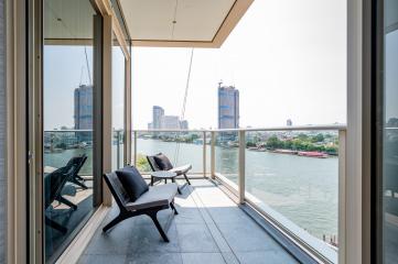 Modern balcony overlooking the river with outdoor seating