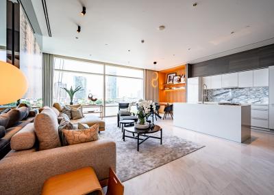 Spacious and modern open plan living room with kitchen, large windows, and city view
