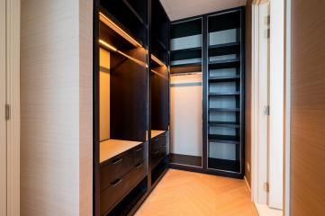 Modern bedroom walk-in closet with built-in lighting