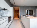 Modern kitchen with marble countertops and built-in appliances