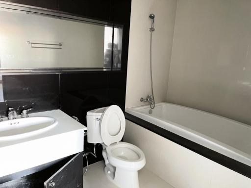 Modern bathroom with bathtub, sink, and toilet