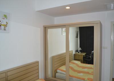 Cozy bedroom with large mirror wardrobe doors and modern lighting