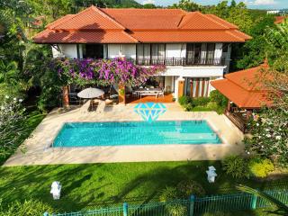 Elegant two-story house with swimming pool and lush garden