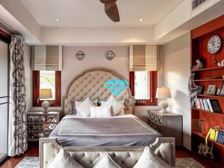 Elegant bedroom with large bed, stylish furniture and beautiful lighting