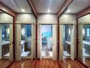 Modern building interior with mirrored closet doors leading to a marble bathroom