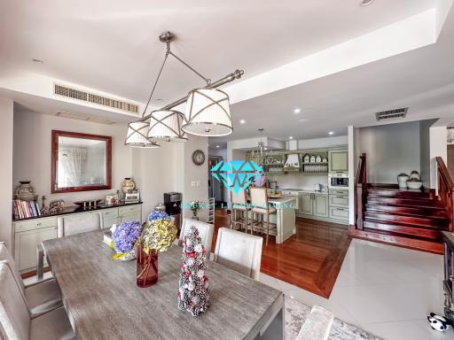 Spacious open concept living room and kitchen area with modern furnishings and ample lighting
