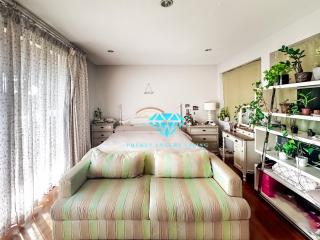 Bright and spacious bedroom with plants and natural light