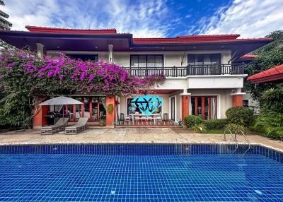 Elegant two-story house with pool and lush garden