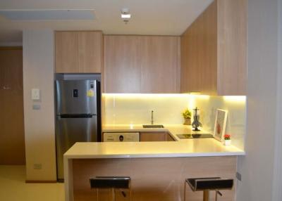 Modern kitchen with wooden cabinets and breakfast bar