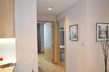 Modern hallway interior with wooden floors and framed artwork