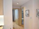 Modern hallway interior with wooden floors and framed artwork