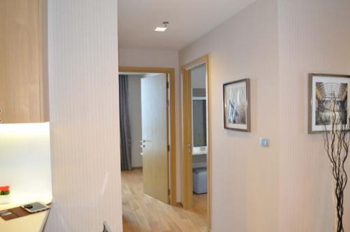 Modern hallway interior with wooden floors and framed artwork