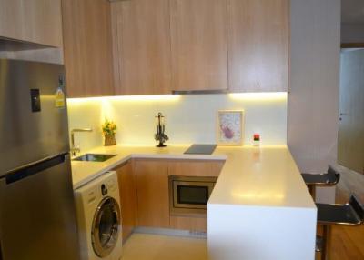 Modern kitchen with wooden cabinets and integrated appliances