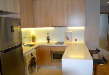 Modern kitchen with wooden cabinets and integrated appliances