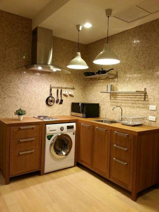 Modern kitchen with wooden cabinets and stainless steel appliances