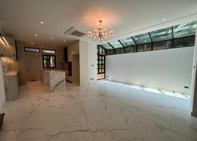 Spacious living area with large windows and marble flooring