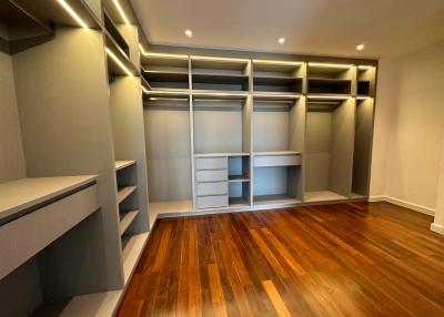 Spacious bedroom with built-in wardrobes and hardwood flooring