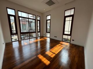 Spacious and bright living room with hardwood floors and large windows