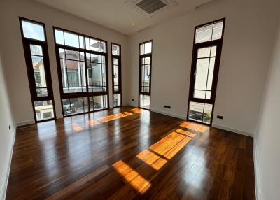 Spacious and bright living room with hardwood floors and large windows