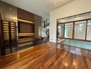 Spacious living room with modern staircase and hardwood flooring