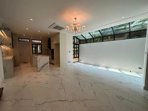Spacious living room with marble flooring and large windows