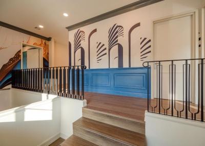 Contemporary hallway interior with decorative wall paneling and hardwood floors
