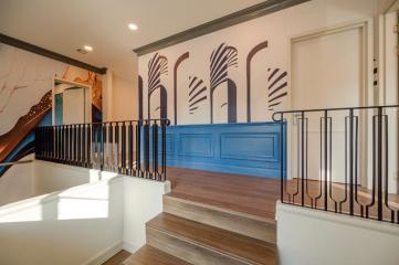 Contemporary hallway interior with decorative wall paneling and hardwood floors