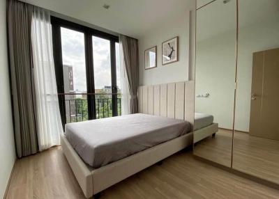 Cozy bedroom with wooden flooring and city view