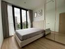 Cozy bedroom with wooden flooring and city view