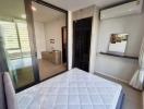 Modern bedroom with a large bed, air conditioning, and ample natural light