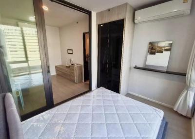 Modern bedroom with a large bed, air conditioning, and ample natural light