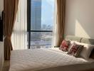 Modern bedroom with a large window overlooking the city