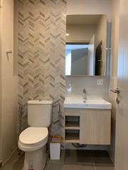 Modern bathroom interior with herringbone tile pattern and sleek fixtures