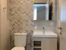 Modern bathroom interior with herringbone tile pattern and sleek fixtures