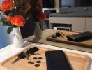 Modern kitchen interior with flowers and wooden cutting board