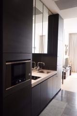 Modern kitchen with sleek black cabinetry and integrated appliances