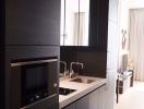 Modern kitchen with sleek black cabinetry and integrated appliances