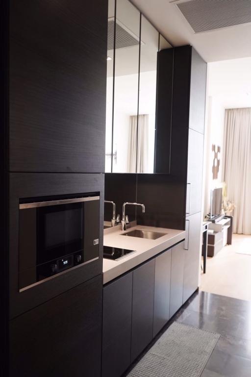 Modern kitchen with sleek black cabinetry and integrated appliances