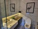 Modern bathroom with marble tiles and artwork