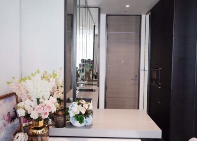 Modern corridor interior with decorative flowers and elegant reflective surfaces