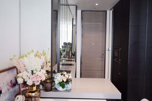 Modern corridor interior with decorative flowers and elegant reflective surfaces