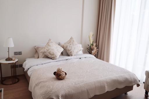 Spacious bedroom with natural light and elegant decor