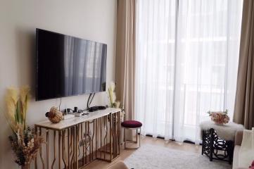 Modern living room with large window and flat-screen TV