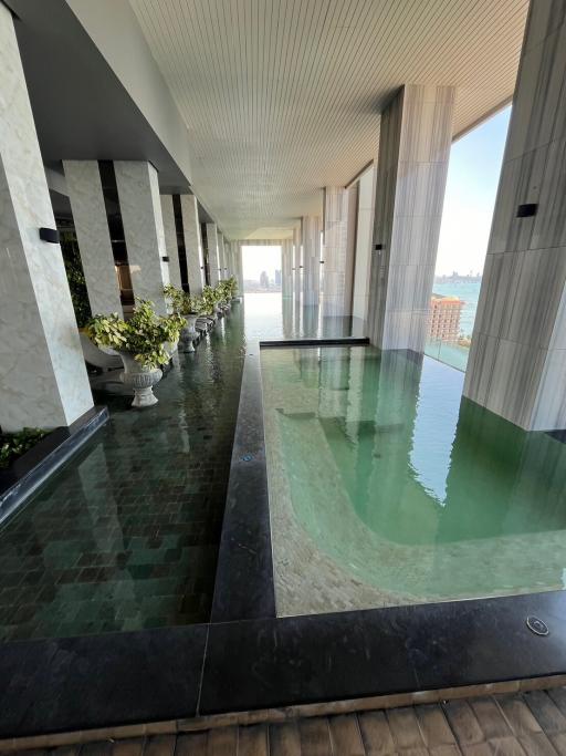 Luxury building indoor pool area with ocean view
