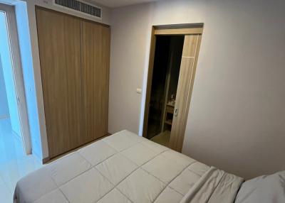 Compact bedroom with large bed and wooden wardrobe
